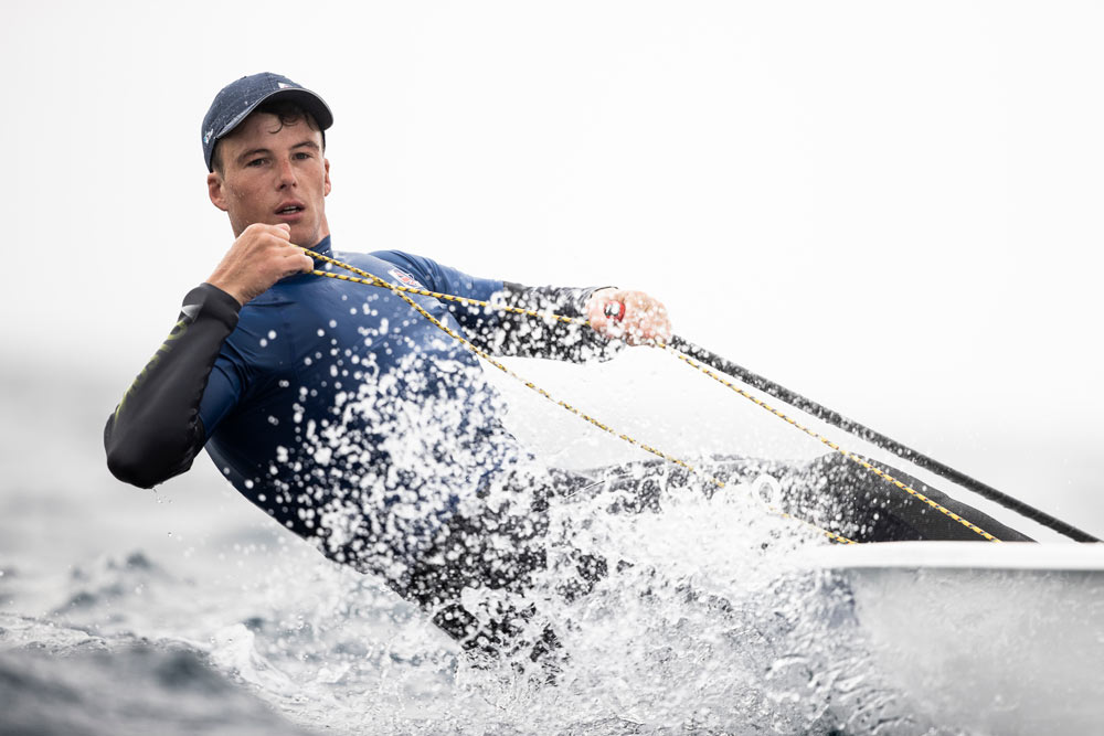 dramatic shot of micky bennet sailing a dinghy through choppy waters